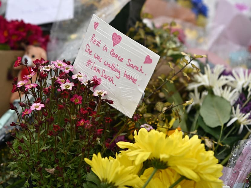 Flowers and tributes are pictured at the entrance to Great Chart Golf and Leisure near Ashford, southeast England on March 18, 2021, near to where the body of Sarah Everard was discovered in woodland.