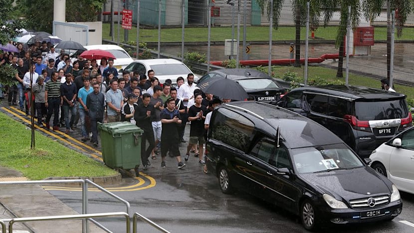 Family, friends brave rain to bid final farewell to murdered businessman