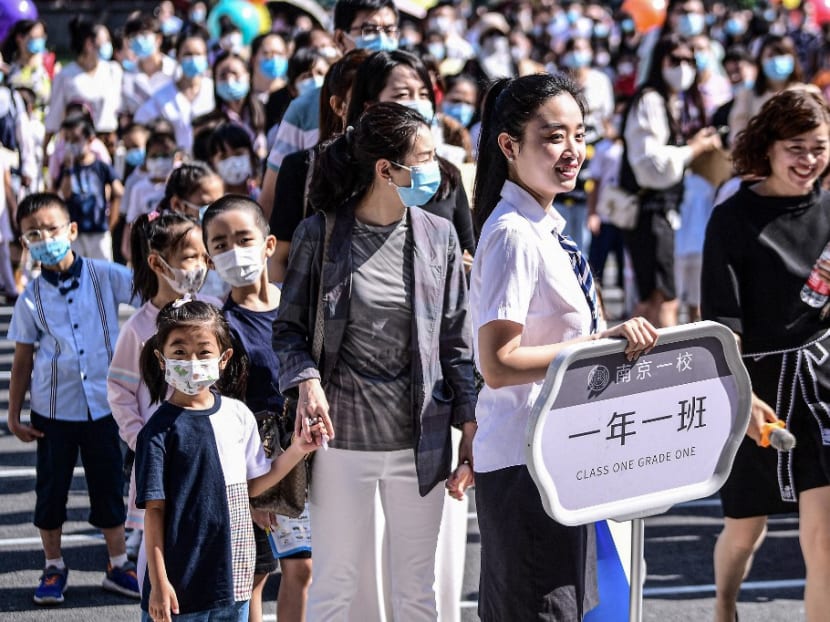First-year pupils arrive at a primary school for the new semester in Shenyang in China's northeastern Liaoning province on Aug 30, 2021.