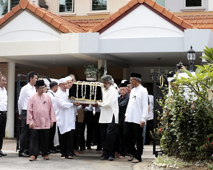 Crowds brave torrential downpour as Othman Wok is laid to rest