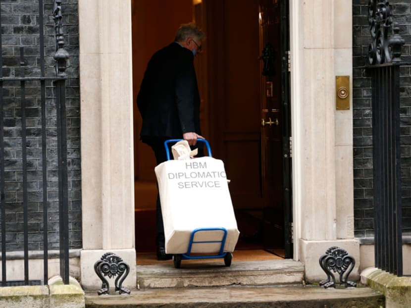 A government employee wheels a diplomatic bag into 10 Downing Street in London, England in January 2021 A government employee wheels a diplomatic bag into 10 Downing Street in London, England in January 2021