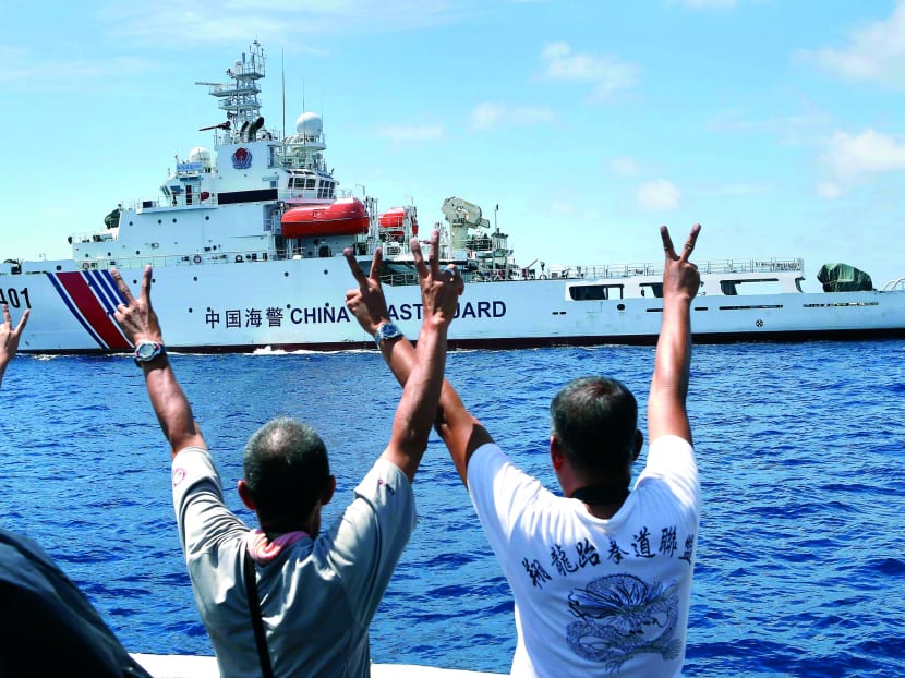 Philippine Marines gesturing at a Chinese Coast Guard vessel, which tried to block a Philippine government supply ship from reaching the disputed Second Thomas Shoal, part of the Spratly Islands, in the South China Sea late last month. PHOTO: Reuters