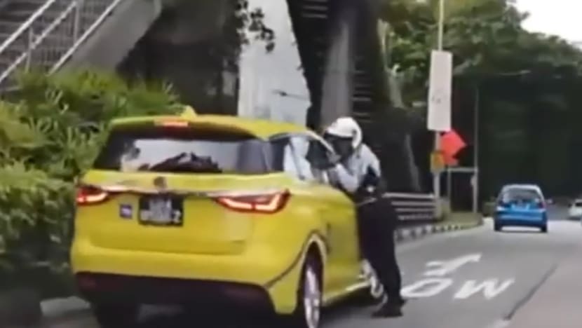 Taxi driver who pinned traffic police officer's arm in window gets jail and driving ban