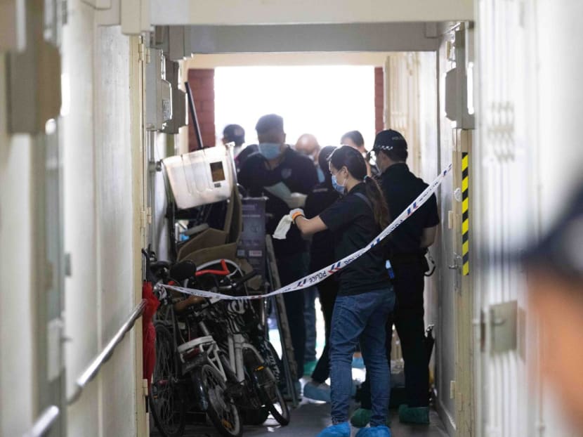 Police officers outside the rental unit at Block 90 Redhill Close where a man was found dead on March 17, 2023.