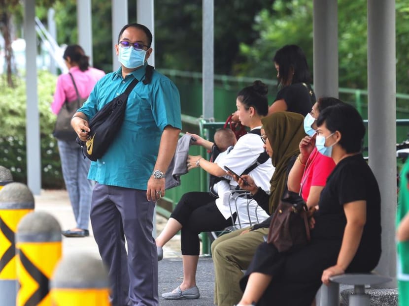 People donning masks to protect themselves from the Covid-19 virus. As of Thursday, there are now 345 confirmed cases of Covid-19 in Singapore.
