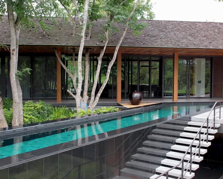 A swimming pool takes centre stage at this tropical modernist architecture in Thailand