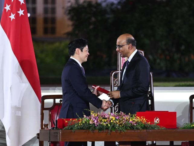 President Tharman Shanmugaratnam (right) shaking hands with newly sworn-in Prime Minister Lawrence Wong as he presented Mr Wong with the Instrument of Appointment, at the Istana on May 15, 2024. 