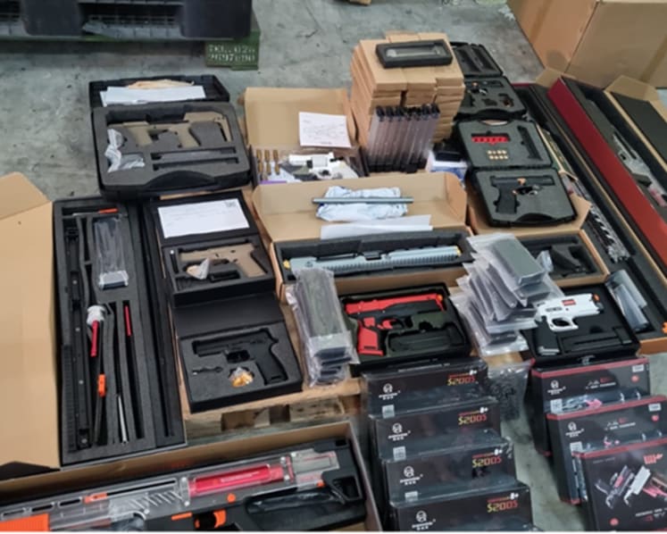 Man arrested, woman under probe after 20 replica guns, 54 gun parts found as illegal imports at Tuas Port