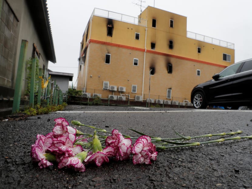 Flowers are placed in front of the torched Kyoto Animation building in respect for the victims, in Kyoto.