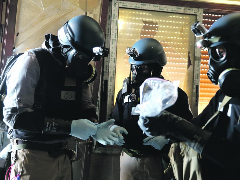 Experts collecting samples in Damascus. The OPCW oversaw the destruction of Syria’s chemical weapons and dispatched experts after a sarin-gas attack killed more than 1,400 people in August. Photo: Reuters