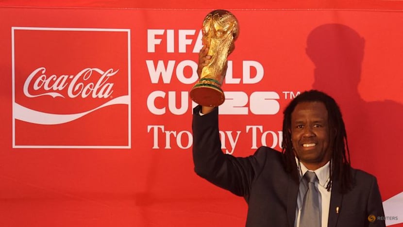 Mexican fans enjoy a brief respite from violence as they gaze at World Cup trophy