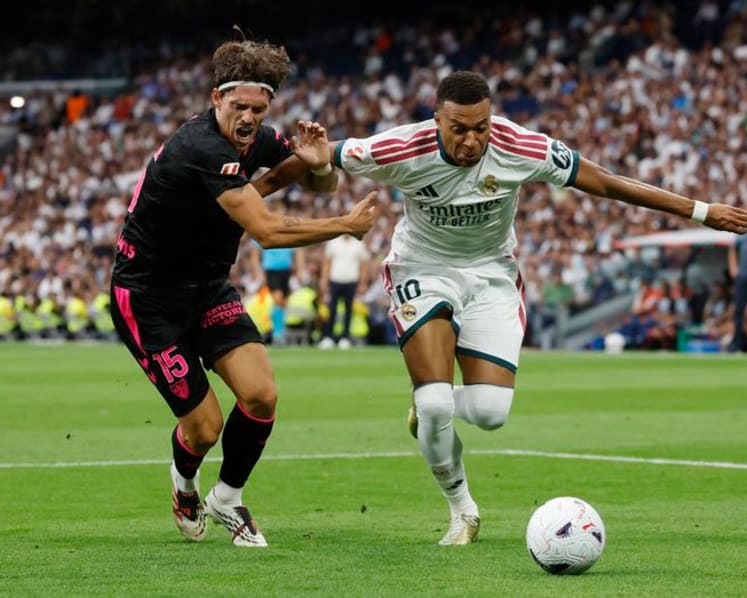 Real Madrid cruise past Malaga 4-0 to maintain perfect start