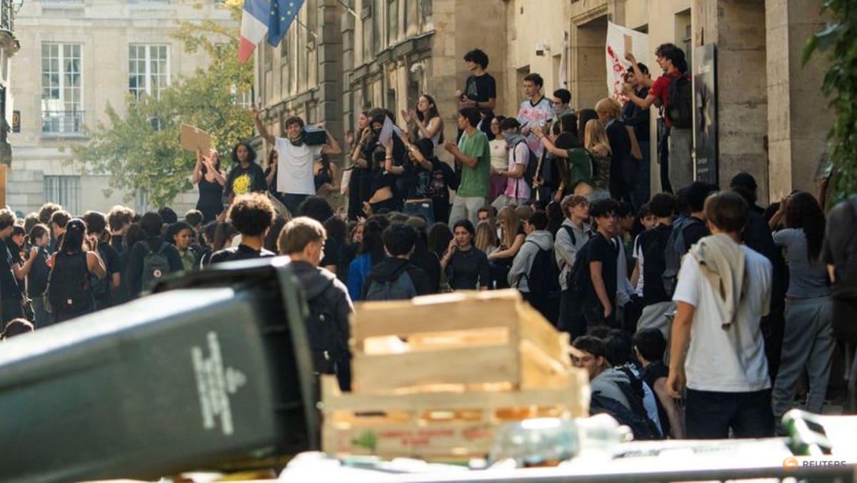 Teenager loses hand picking up grenade in France school protests - CNA