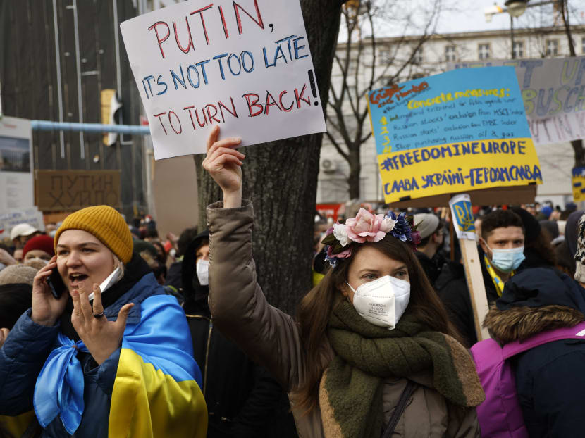 Protestors holding placards stand in front of the Russian embassy in Berlin to demonstrate for peace in Ukraine on Feb 27, 2022. Protestors holding placards stand in front of the Russian embassy in Berlin to demonstrate for peace in Ukraine on Feb 27, 2022.