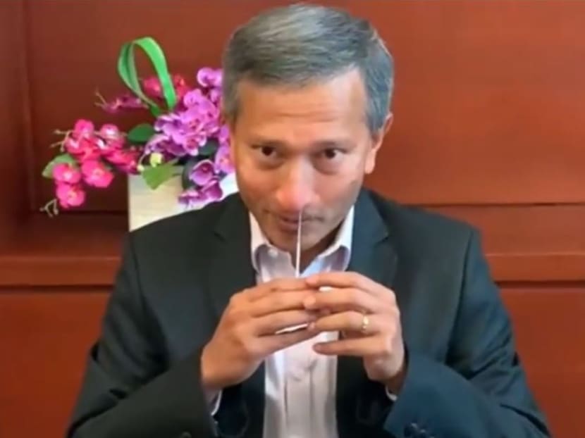 Dr Vivian Balakrishnan demonstrating how the antigen rapid test is done.
