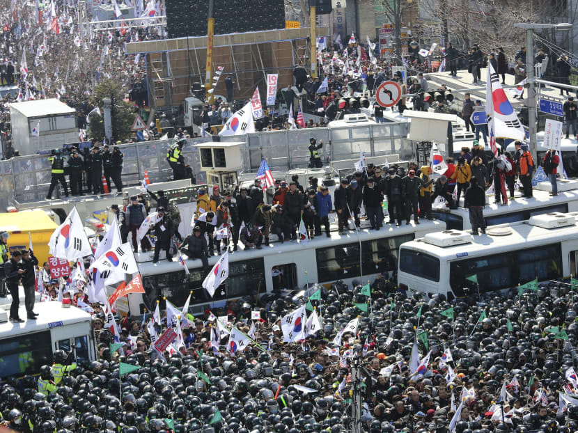 South Koreans jubilant, or stunned by president’s sacking