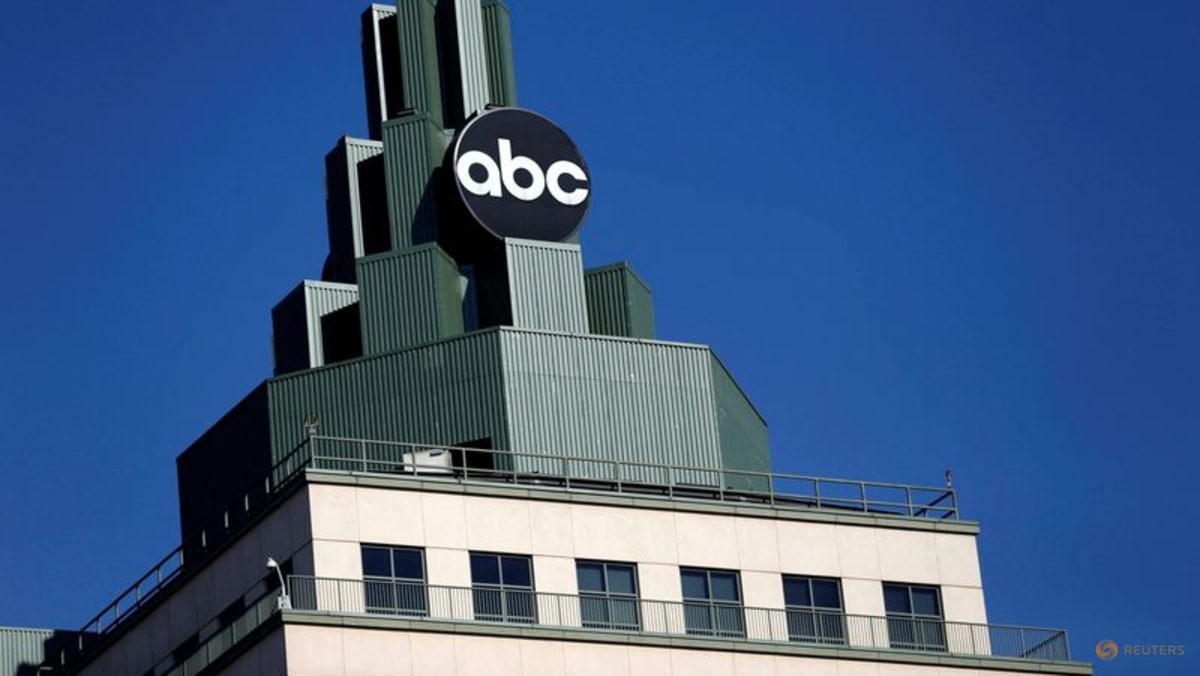 A building with a green upper section displaying the abc logo against a blue sky.