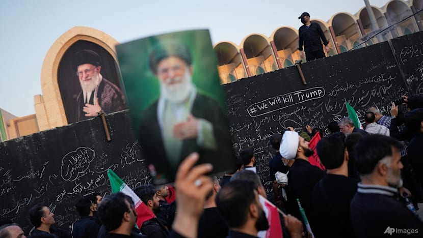 Three sons of Iran's slain leader appear at funeral, not his successor
