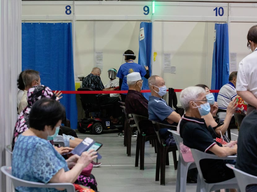 People waiting to get immunised against Covid-19 at a vaccination centre.