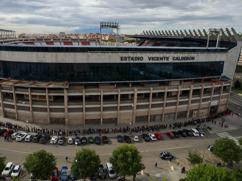 Atletico Madrid fans queuing for tickets outside the Estadio Vicente Calderon. Atletico will play their final league game here on May 21, and a week 

later, after a showpiece exhibition game, the stadium will be closed for good. Two skyscrapers will rise in its place alongside a public park. Photo: Getty Images