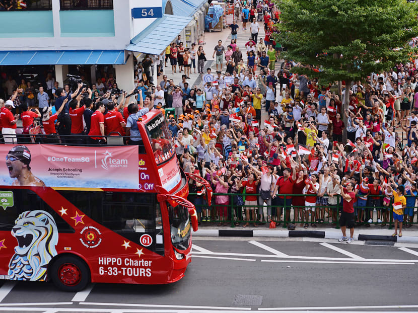 Singapore swimmer Joseph Schooling (on the bus) greeting adoring supporters during his victory parade at Marine Terrace, on Aug 18, 2016. Photo: Robin Choo