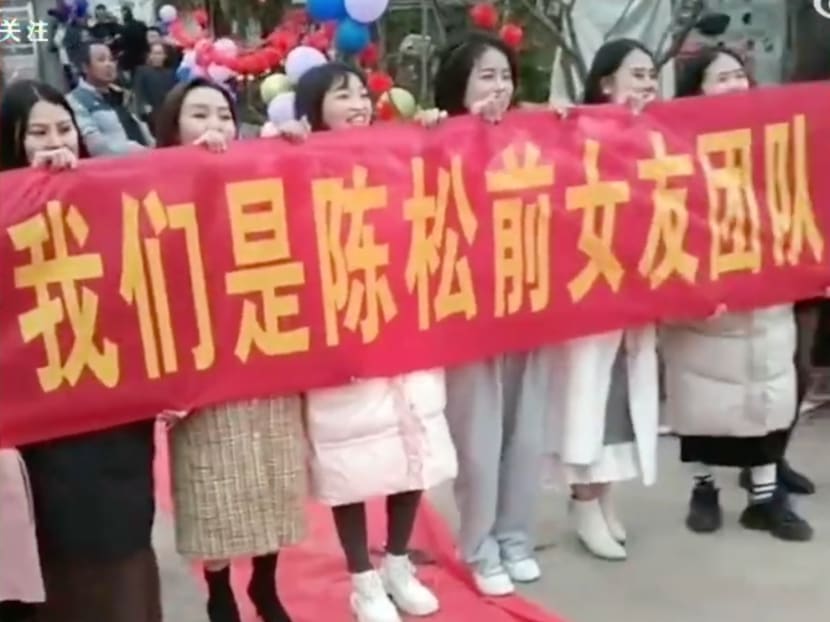 A group of women reportedly showed up to humiliate the groom at a wedding in Yunnan province, China, with a banner that read: "We are Chen Song's ex-girlfriend team, today we will destroy you". A group of women reportedly showed up to humiliate the groom at a wedding in Yunnan province, China, with a banner that read: "We are Chen Song's ex-girlfriend team, today we will destroy you".