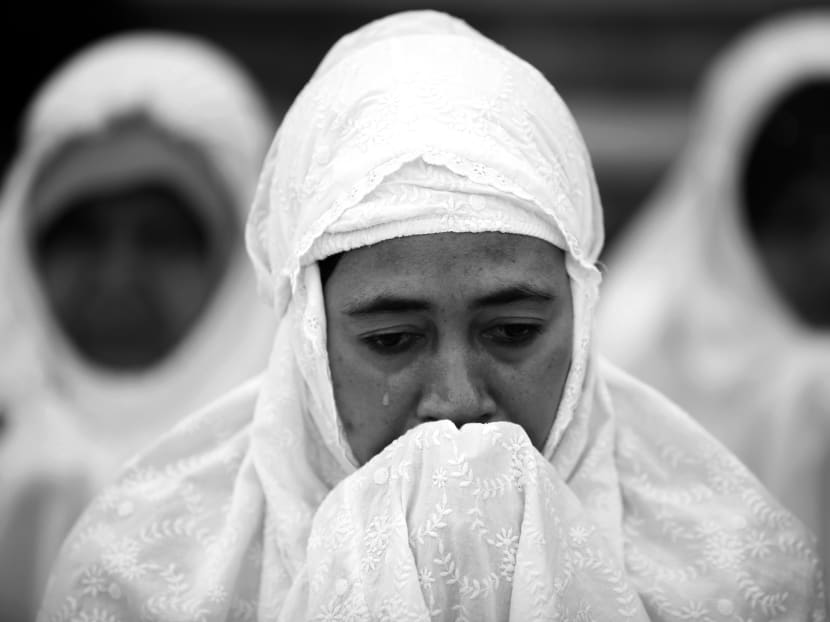 A Muslim woman at prayer in Kuala Lumpur. The hudud law debate in Malaysia ignores the fact that modern laws also uphold Islamic values and principles such as justice, freedom of faith and human rights. Photo: REUTERS