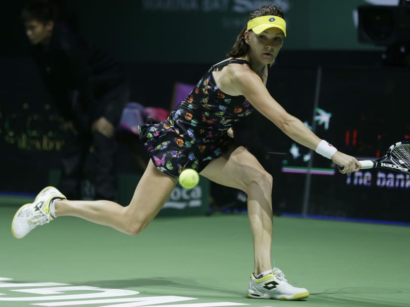 Poland's Agnieszka Radwanska makes a backhand return to Petra Kvitov of the Czech Republic during their singles match at the WTA tennis finals in Singapore. Photo: AP