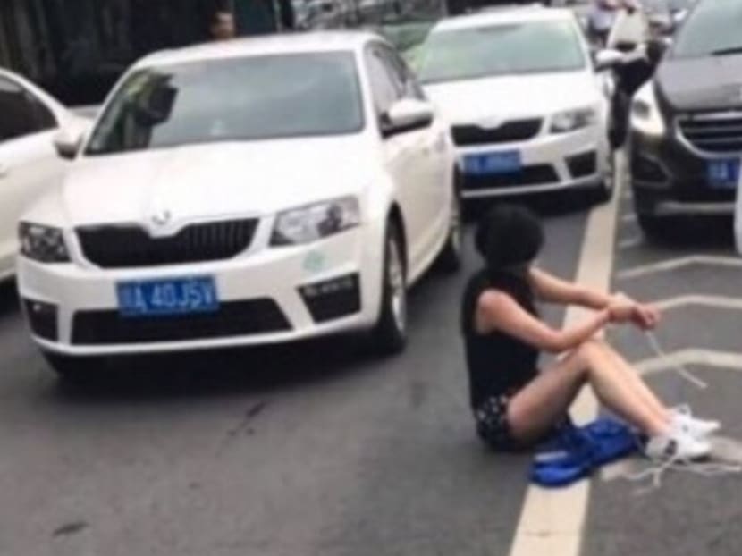 Witnesses described how the woman, whose feet and wrists had been tied, fell out of the boot when it flew open in the crash in Chengdu, the capital of Sichuan province.