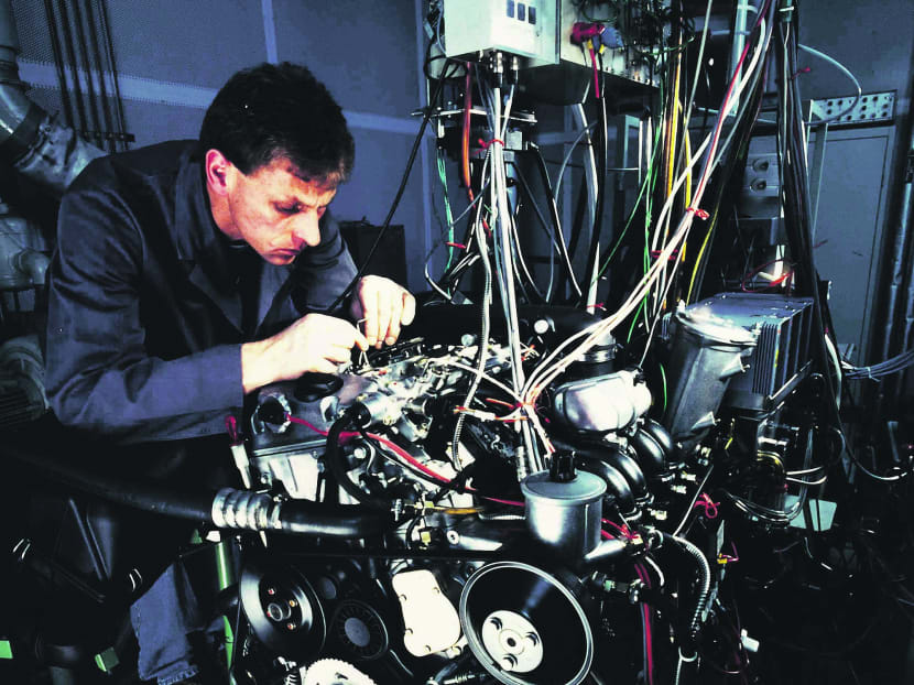 A Bosch technician working on an engine. The company is one of the world’s leading suppliers of automotive components. Photo: Bloomberg