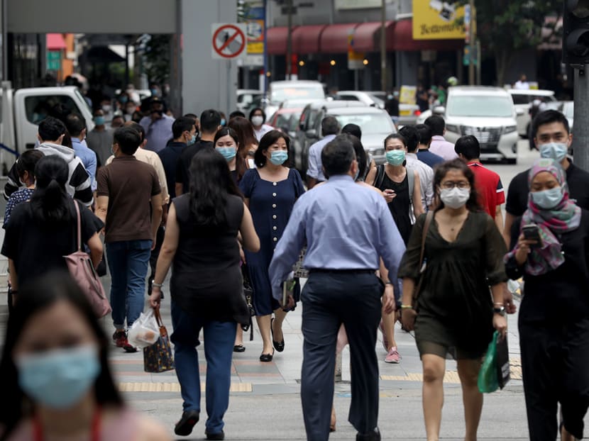 People are seen in the Central Business District in Singapore.