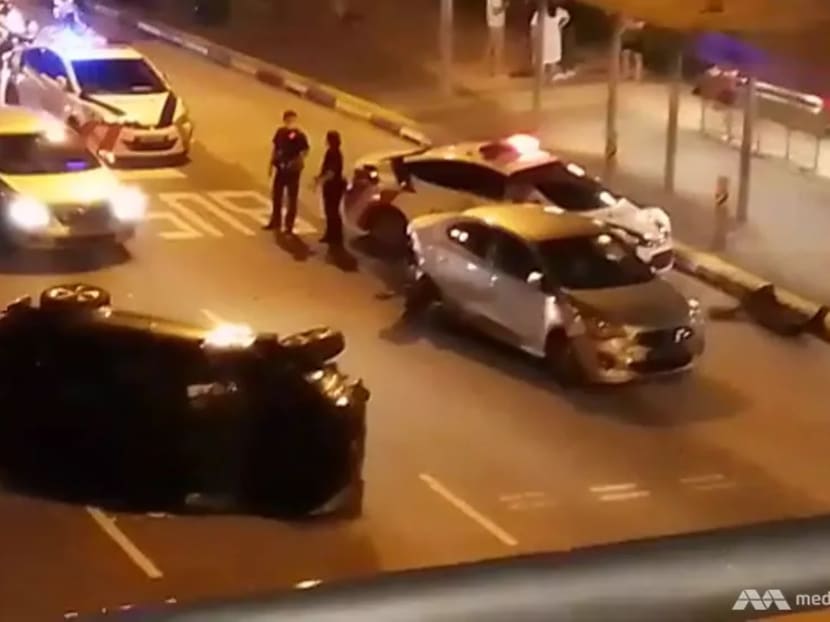 A screengrab from a video showing a car on its side on Punggol East Road near Riveria LRT.