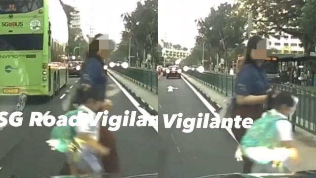 妇女带女童危险过马路 司机急踩刹车避免车祸