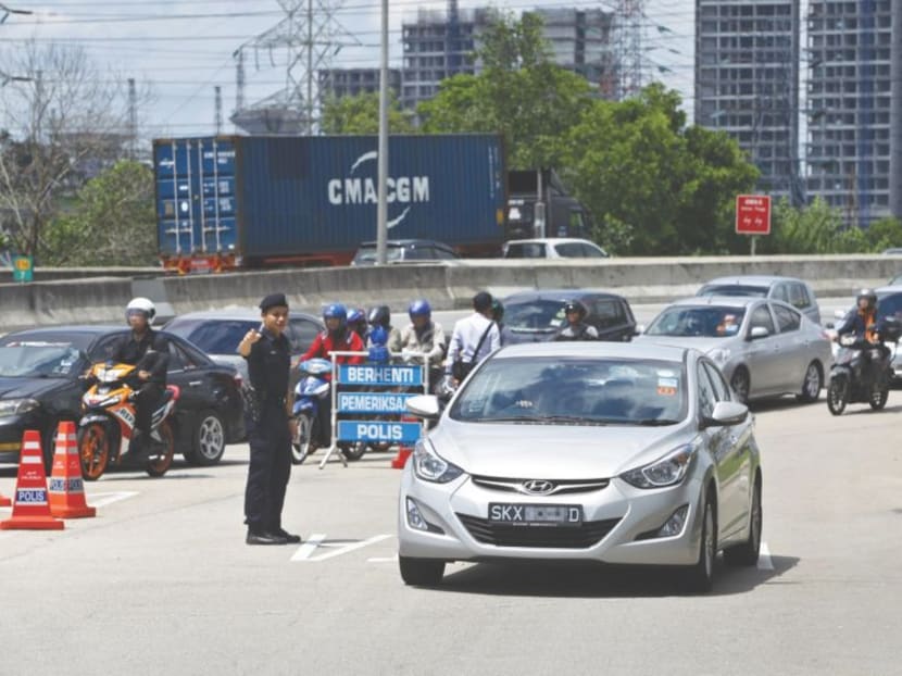 A vehicle stopped at a roadblock near the Pandan Rest and Relaxation stop at the Eastern Dispersal Link.