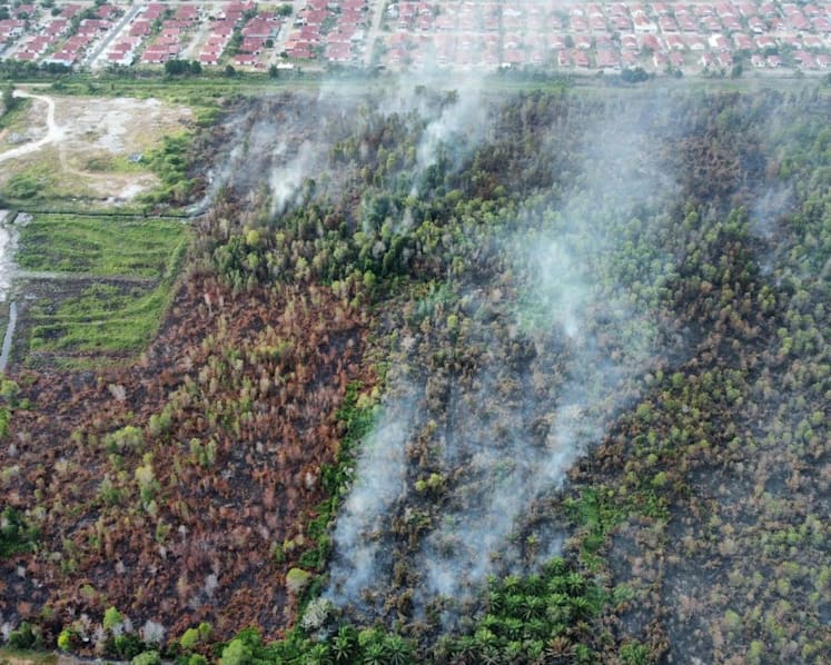 Johor conducting water bombing for partially controlled Pengerang peatland fire