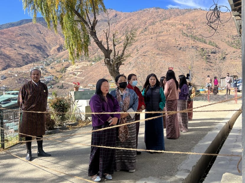 Bhutanese citizens queue to vote at a polling station in the capital Thimpu on November 30, 2023, in primary polls to choose the top two political parties who will contest the general election in January