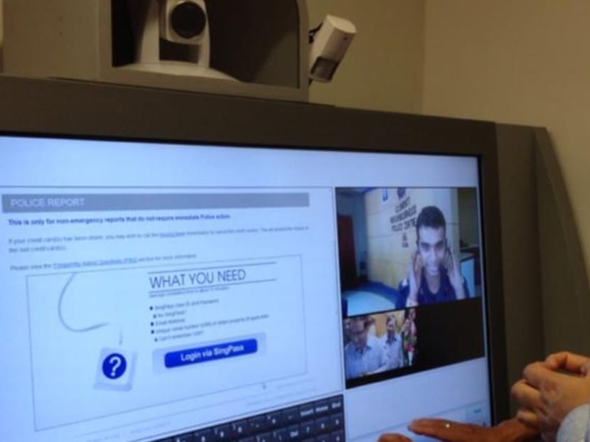 Former Second Minister for Home Affairs S Iswaran trying a self-service kiosk in 2013. Photo: Singapore Police Force/Facebook