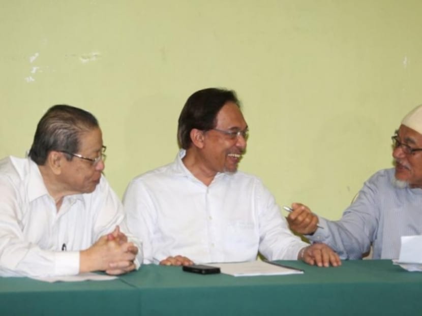 Mr Anwar Ibrahim (centre), Mr Abdul Hadi Awang (right) and Mr Lim Kit Siang having a meeting before the 'Faham GST, Tolak GST' rally at Sultan Sulaiman Club, Kg Baru. Photo: The Malay Mail Online