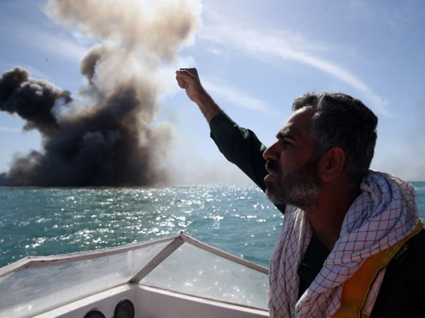 A member of Iran's elite Revolutionary Guards chants slogans after attacking a naval vessel during a military drill in the Strait of Hormuz in southern Iran on Feb 25, 2015. Photo: AFP