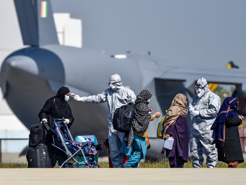 Doctors check Indian citizens after they were brought to India by the C-17 Globemaster III aircraft of the Indian Air Force (IAF) from Iran, amid the Coronavirus outbreak.