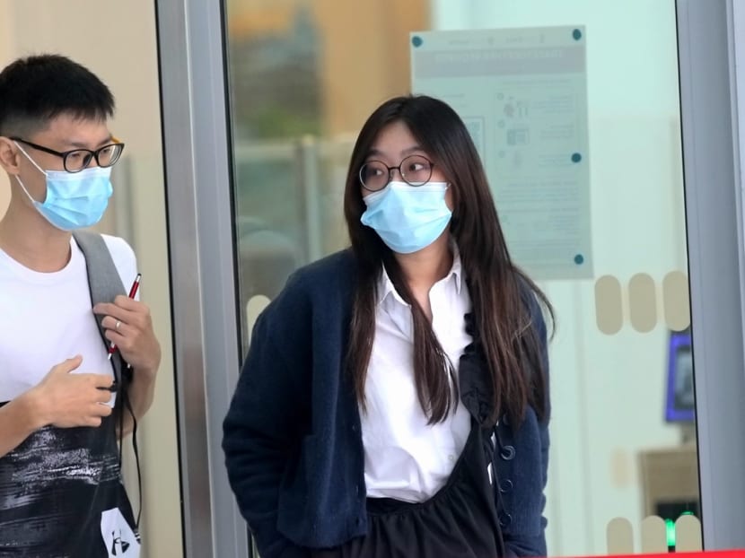 Cao Wenqing (right) faces 16 charges of unauthorised access to computer material under the Computer Misuse Act, and 13 charges of unauthorised disclosure of customer information under the Banking Act.