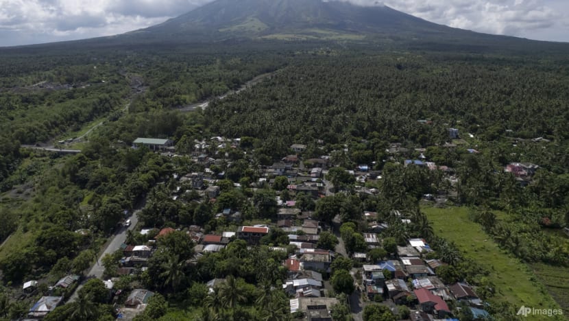 Poor villagers risk their lives in danger zone as Philippines' most active volcano erupts Poor villagers risk their lives in danger zone as Philippines' most active volcano erupts