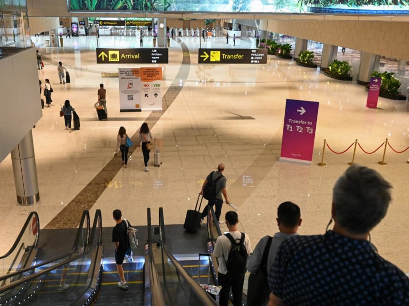 Passengers head towards an immigration checkpoint at Changi Airport Terminal 4 in 2022. Passengers head towards an immigration checkpoint at Changi Airport Terminal 4 in 2022.