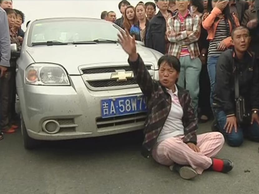 Gallery: China farm fire: Relatives scuffle with police, demand answers