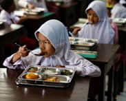 Some remote Indonesian communities still await free meals as programme resumes after review