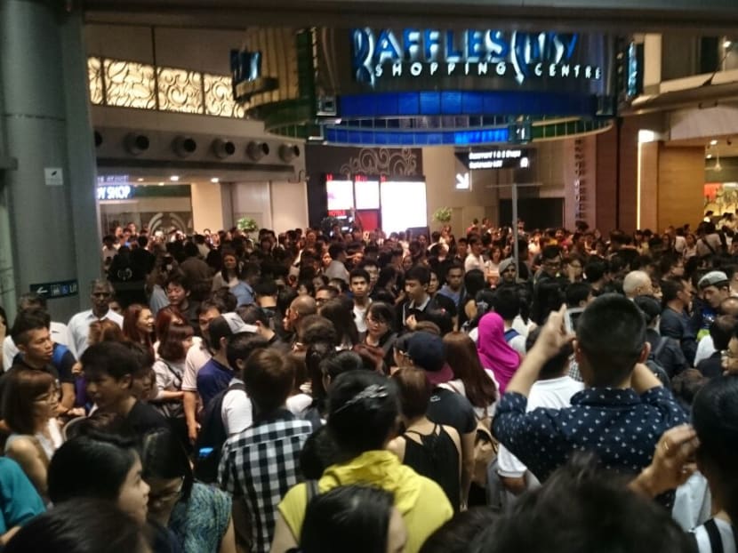 The crowd outside City Hall MRT station on March 27, 2015. The State Funeral Organising Committee has announced a temporary closure of the queue for the lying-in-state at Parliament House. Photo: Raj Nadarajan