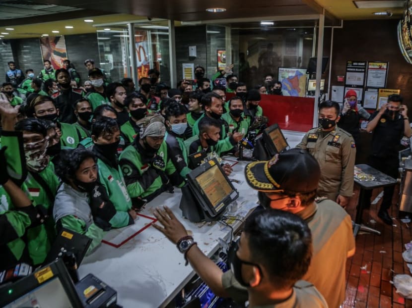 Food delivery riders queue up at a McDonald’s outlet in Bogor on June 9, 2021, to buy the new BTS-meal deal for hungry fans in the K-Pop mad country, causing more than a dozen McDonald's outlets to temporarily shuttered over virus fears. Food delivery riders queue up at a McDonald’s outlet in Bogor on June 9, 2021, to buy the new BTS-meal deal for hungry fans in the K-Pop mad country, causing more than a dozen McDonald's outlets to temporarily shuttered over virus fears.