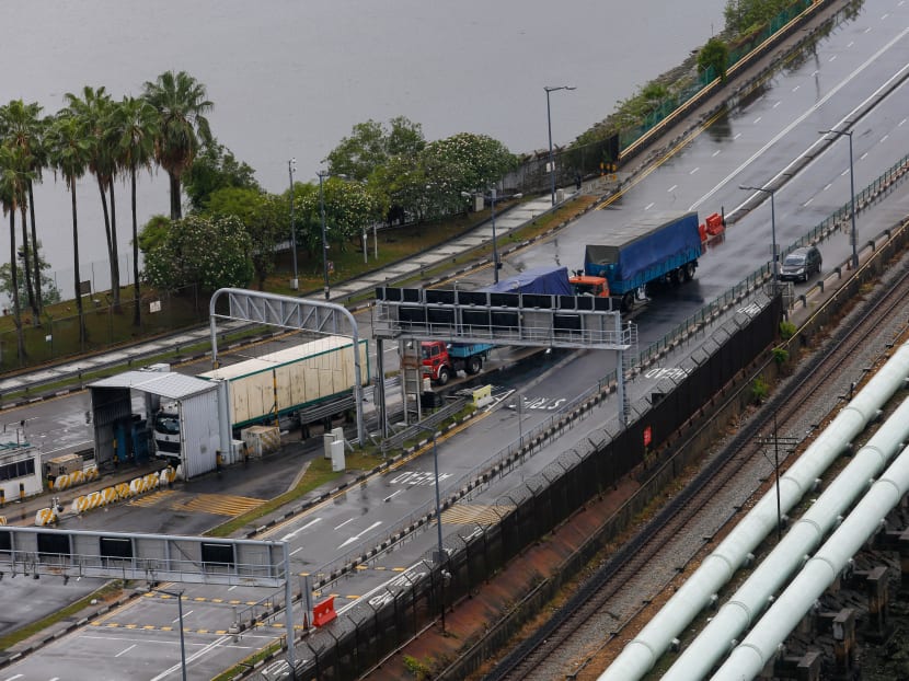 Trucks transporting goods between Singapore and Malaysia seen at the Causeway on March 18, 2020.