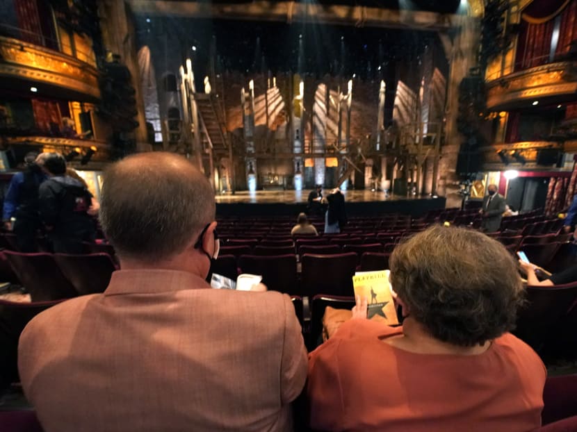 Attendees wait for the start of the Broadway musical "Hamilton" on September 14, 2021 at the Richard Rodgers Theatre in New York, as the highest grossing Broadway musical of all time returns after being dark for 18 months due the coronavirus pandemic. Lion King, Wicked and Chicago also opened for the fully vaccinated.