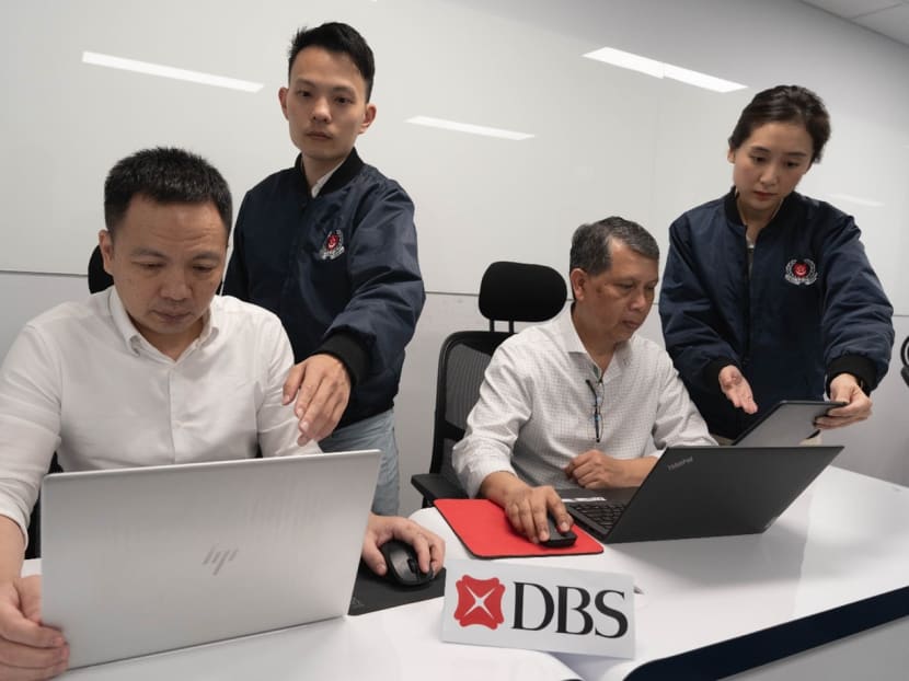 Officers from the Anti-Scam Centre seen working together with DBS Bank staff during the one-month joint operation from June 12 to July 11, 2023.